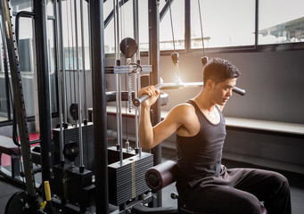 Personal trainer weight-lifting in fitness center