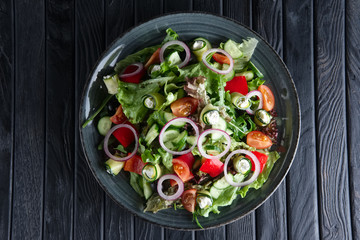 Salad with fresh cucumber, tomato, bell pepper, feta and onion