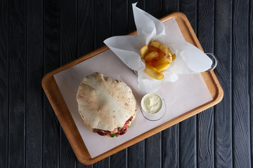 Pita bread with fried stuffing, beans and vegetables served with fried potato