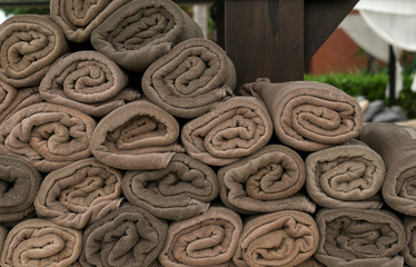Bath towel rolls brown fabric texture cloth background used for swimming pool, sea beach, gym fitness in resort hotel