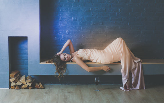 Sexy woman in front of the fireplace. Wood fireplace.