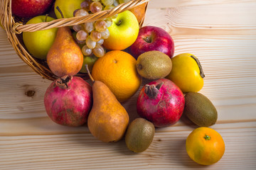 Composition with assorted fruits in wicker basket, healthy life