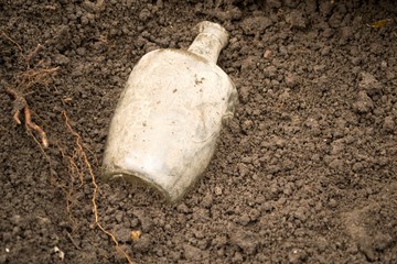 bottle in the ground