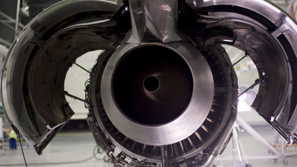 Engine of the airplane under heavy maintenance. Aircraft maintenance, dismantled plane engine. Chassis of the airplane under heavy maintenance