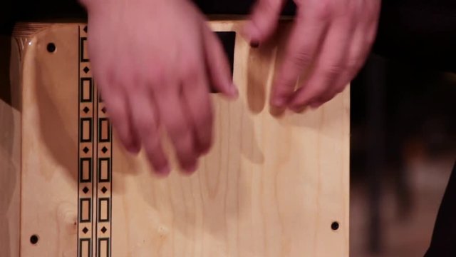 A drummer musician plays a percussion instrument Cajon. Close-up. Footage on a musical theme.