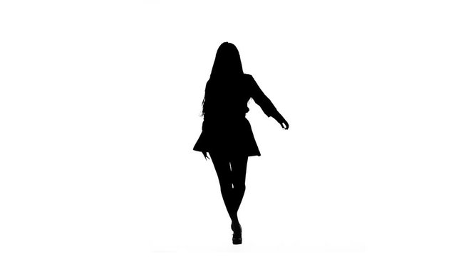 Woman is dancing a sexy dance. Silhouette. White background