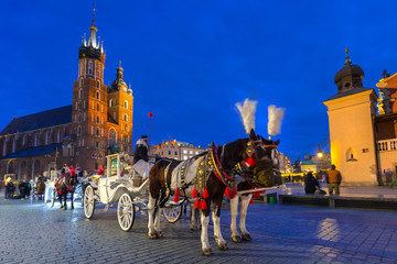 Naklejka na ściany i meble Horse carriages at the Main Square in Krakow, Poland