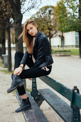 Beautiful young woman in the Luxembourg garden of Paris on a fall day