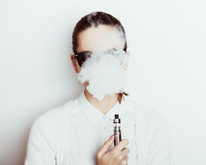 Woman in sunglasses smokes an e-cigarette © progressman