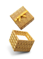 Golden flying open gift box with yellow satin bow