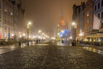Fototapeta na wymiar Misty scenery. Night at medieval Long Market street (Dlugi Targ) in Gdansk. Poland.