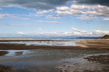 Beautiful reflections on Waiotahe Beach in Opotiki, New Zealand 