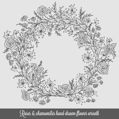 Laurel wreath frame with roses, chamomiles and flourishes. Decorative element in engraving style, hand-drawn floral doodle decor for cards or design.