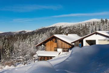 Daylight fades over a snow-covered suburban home