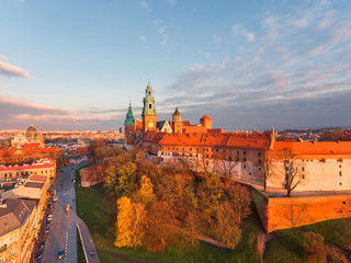Aerial view at gold autumn sunset time of royal Castle in Cracow  city center, Vistula river....