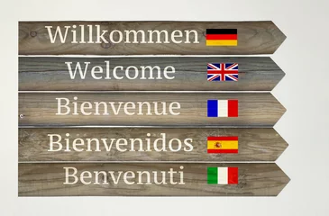 Rolgordijnen Welcome in five languages on the Signboard © vali_111