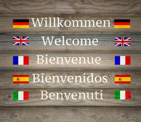 Gordijnen Welcome in five languages on the Signboard © vali_111