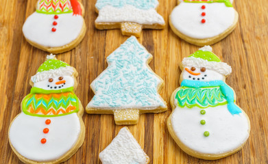 Christmas snowman and tree cookies on the cutting board winter selebration background.