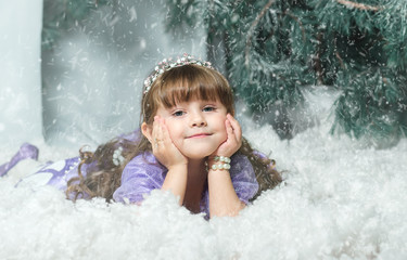 The little girl in the snow against a backdrop of spruce, Studio photoshoot. new year2018, New Year's decorations