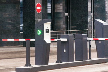 The protective barrier and security office at the entrance to the office parking lot