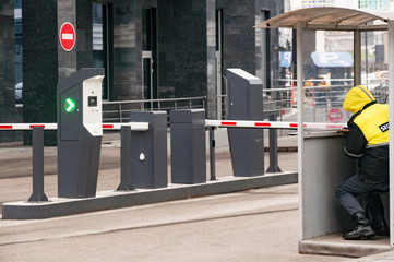 The protective barrier and security office at the entrance to the office parking lot