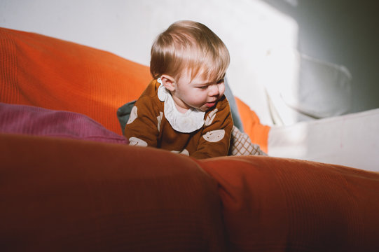 baby on an orange couch
