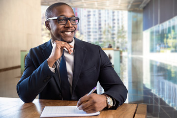 Smiling cheerful happy african american male business executive sales representative at luxury building lobby