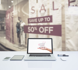 Laptop computer with shopping mall on background