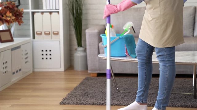 tired cleaning woman doing housework