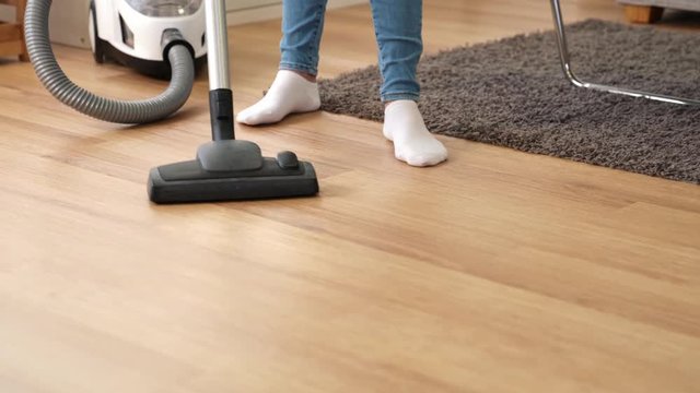 women use vacuum cleaner to cleaning at home
