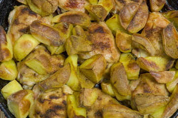 
Fried chicken thighs with potatoes.