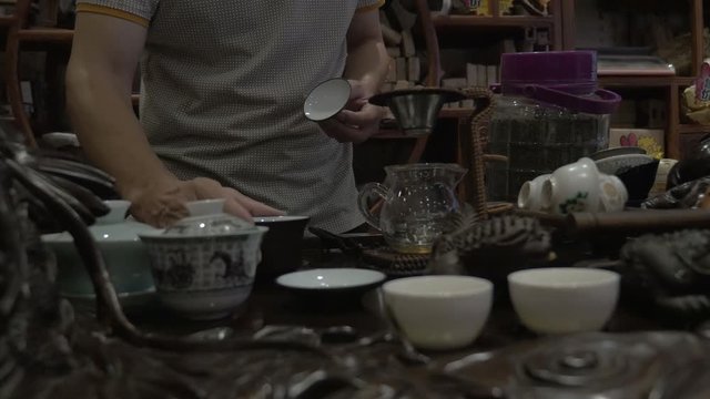 Close up, person pours tea in antique cups