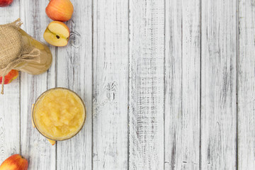 Old wooden table with fresh made Applesauce