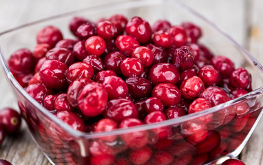 Some fresh Cranberries (preserved) (selective focus; close-up shot)