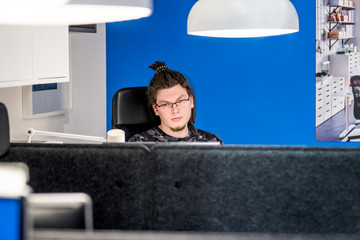 young caucasian man working in the office with computer