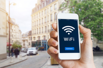 Public WiFi hotspot connection, city street, access internet on smartphone