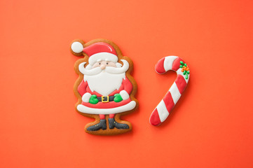 Festive Christmas concept background. Santa and candy canes from gingerbread  cookies. Top view.