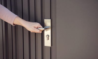 Women hand opening the door.