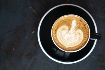 Hot latte coffee with black cup
