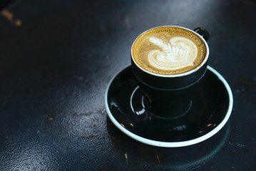 Hot latte coffee with black cup