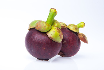 Mangosteen fruit and cross section showing the thick purple skin and white flesh of the queen of fruits.