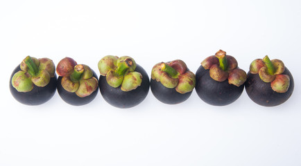 Mangosteen fruit and cross section showing the thick purple skin and white flesh of the queen of fruits.