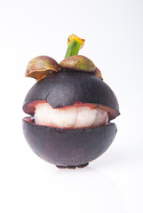 Mangosteen fruit and cross section showing the thick purple skin and white flesh of the queen of fruits.