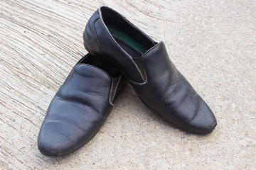 Black leather shoes on the cement