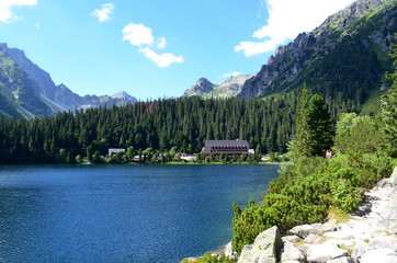 Popradske Pleso mountain lake in High Tatras mountain range in Slovakia - a beautiful sunny summer day in a popular hiking and travel destination in Central Europe
