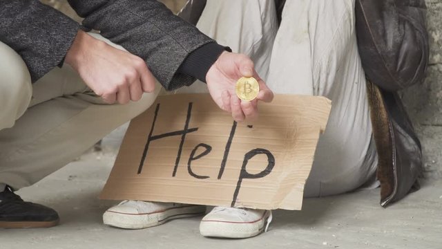 Rich man with bitcoin at the background of dirty homeless