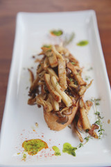 Crispy toasted white bread with mushrooms on wood background table