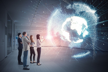 Group of people watching holographic of the earth. Astronomy concept. © metamorworks
