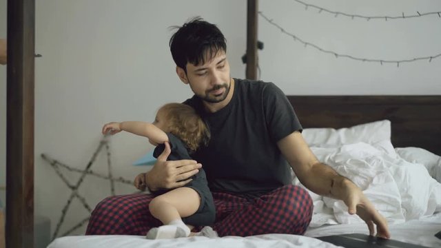 Young father upset because his daughter and wife bother him to work at home