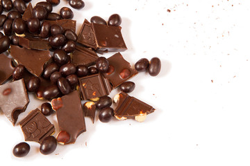 Dark chocolate with hazelnut and chocolate dragee on clean white background